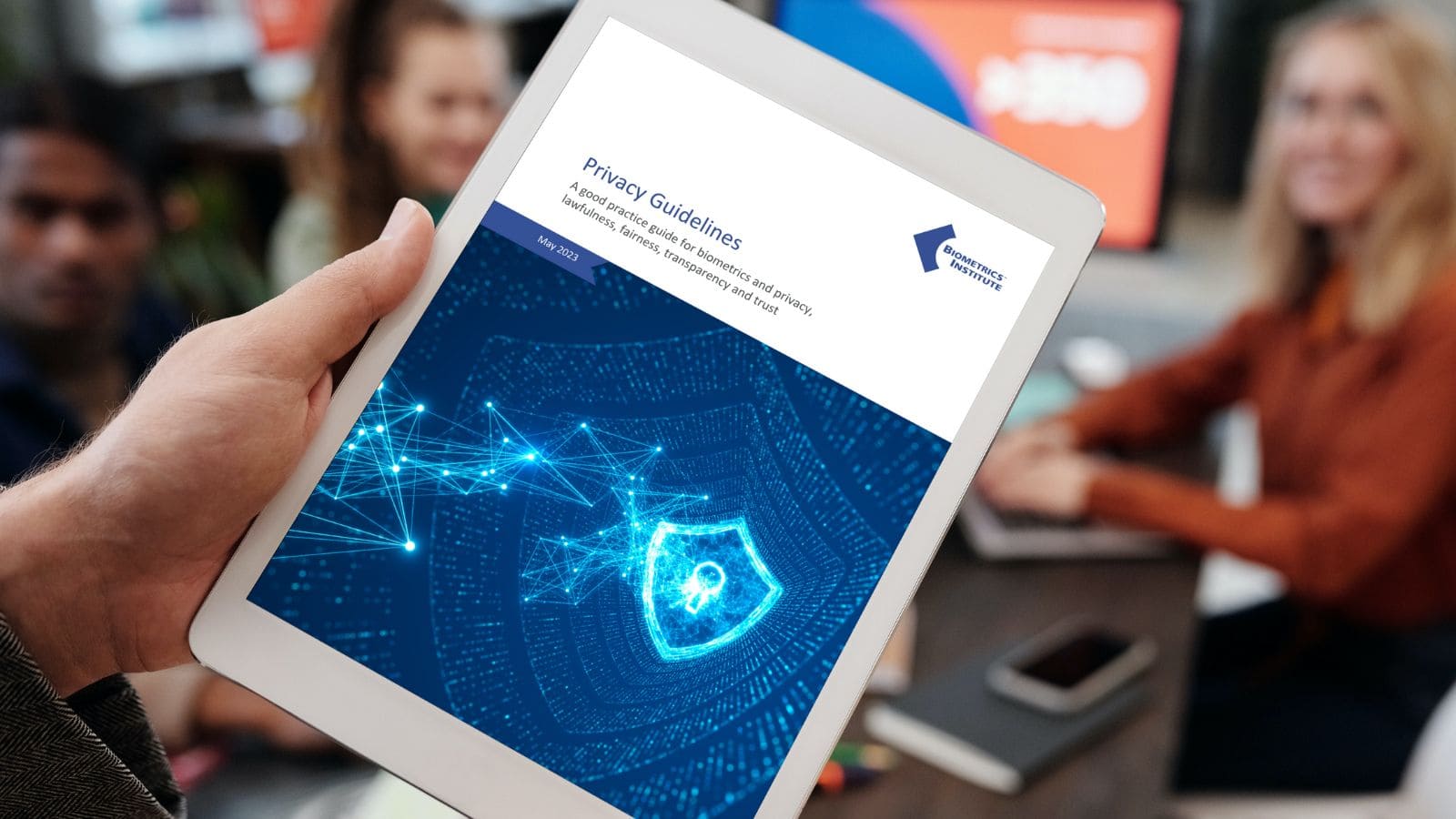 Colleagues viewing the Biometrics Institute’s Privacy Guidelines on an iPad